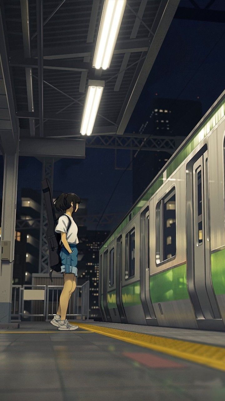 a woman is standing in front of a subway train at night with her back to the camera