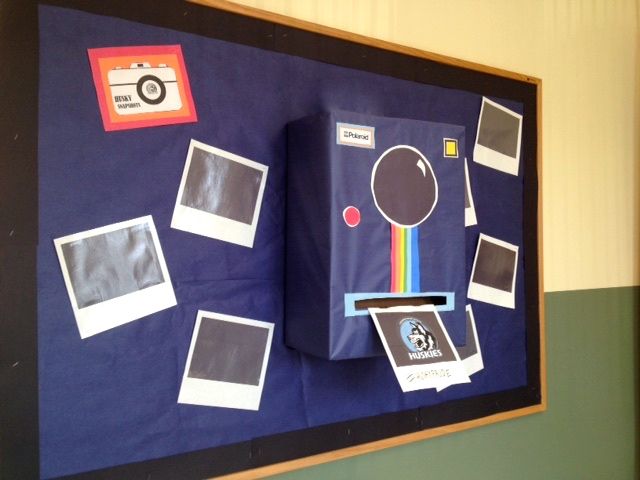 a bulletin board with polaroid pictures attached to it and magnets on the back