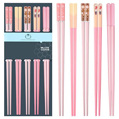 six pink and gold colored chopsticks with different designs