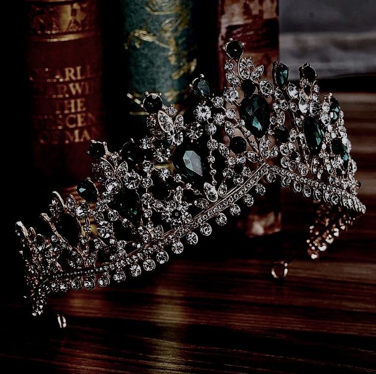 a tiara on a table with books in the background