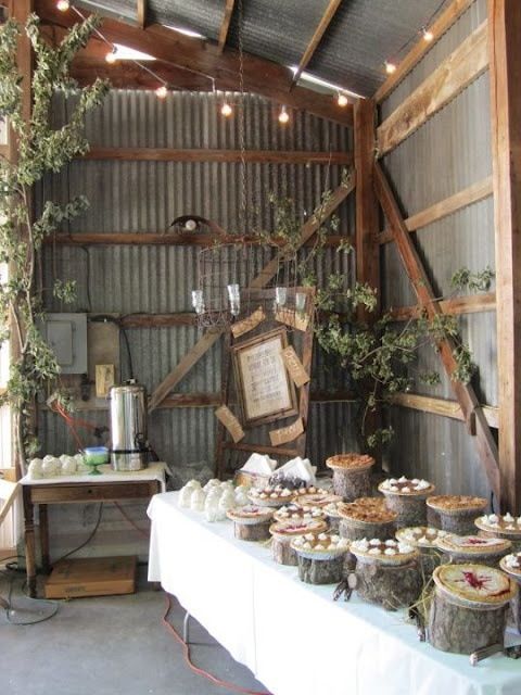 a table topped with lots of pies and cupcakes on top of it