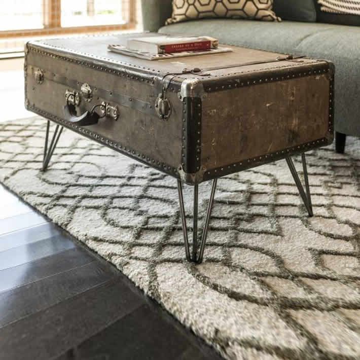 an old trunk is sitting on top of a coffee table in front of a couch