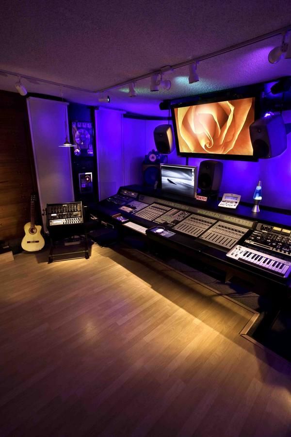 a recording studio is lit up with purple lighting