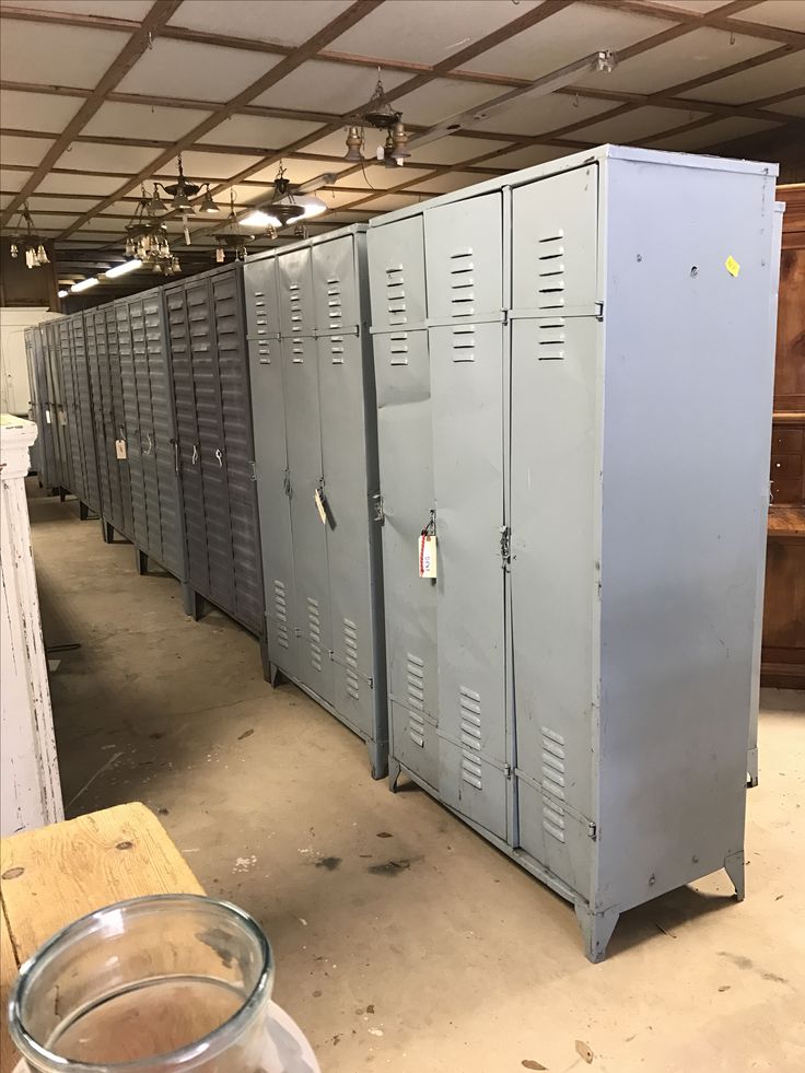 a row of metal lockers sitting inside of a building next to a glass bowl