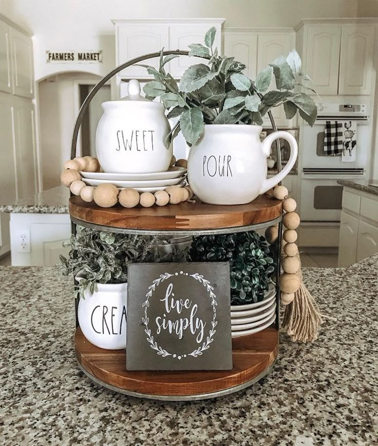 a kitchen counter with coffee mugs and signs on it's shelf, in front of an oven