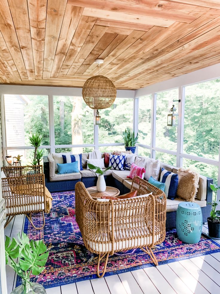 a living room filled with lots of furniture on top of a blue and white rug