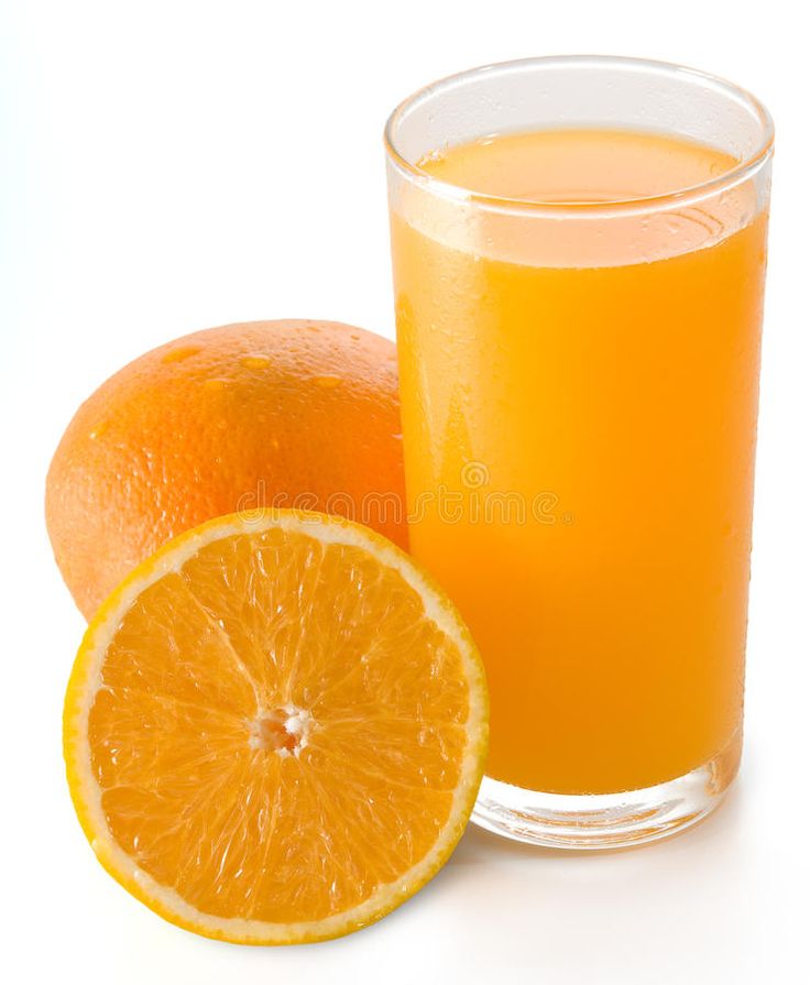 orange juice in a glass next to an orange slice