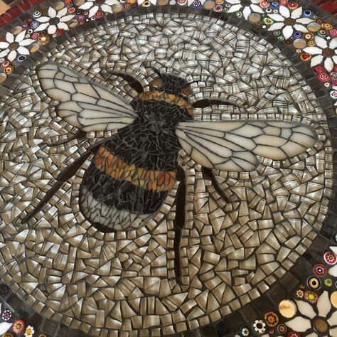 a mosaic with a bee on it