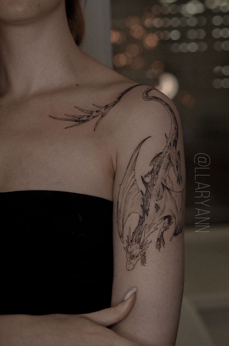 a woman with a dragon tattoo on her arm