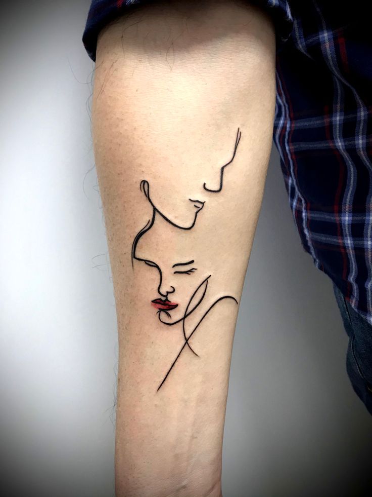 a woman's arm with a tattoo on it that has a line drawing of her face