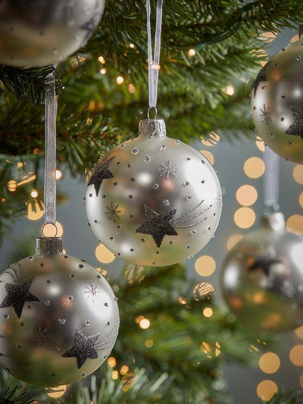 silver and white ornaments hanging from a christmas tree