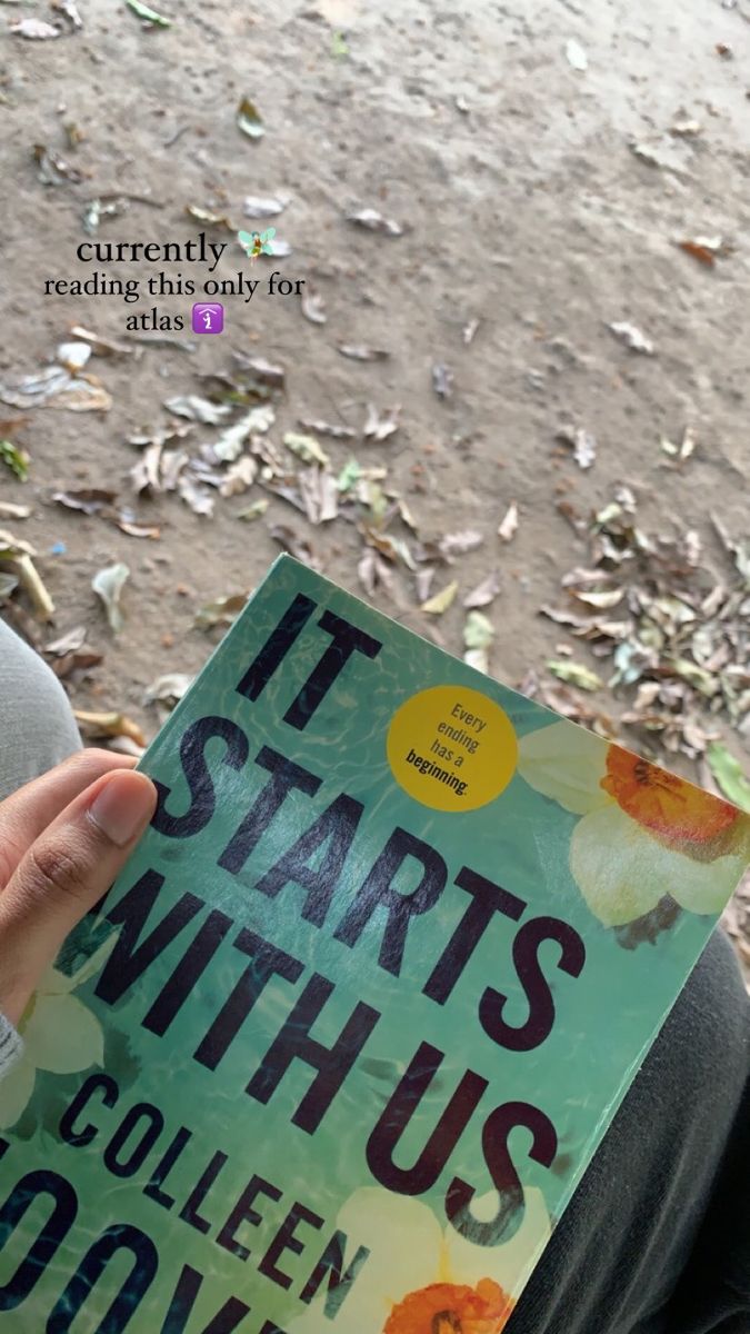 a person holding up a book in front of their face with the title it starts with us written on it