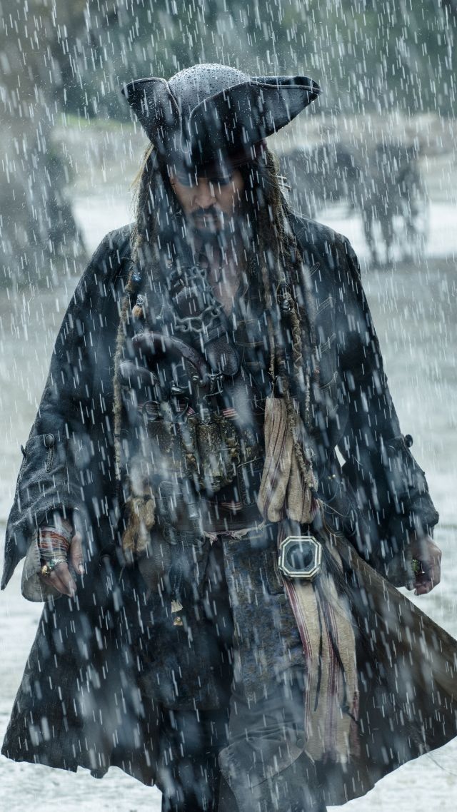 a man in pirate costume walking through the rain