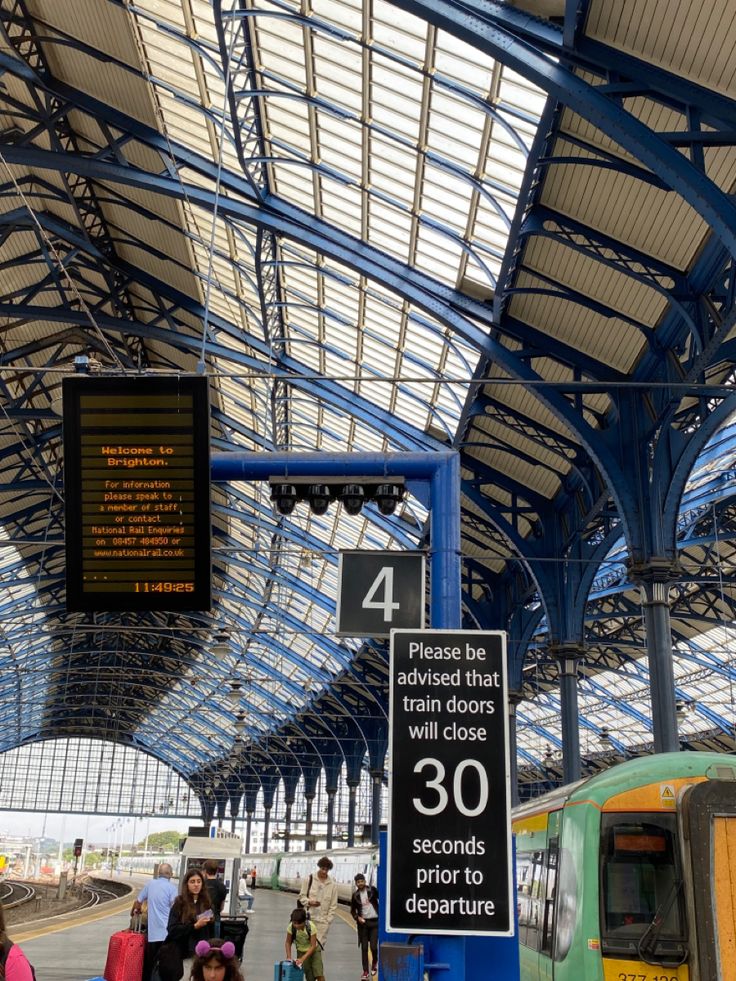 people are waiting at the train station for their trains to arrive and depart in the day