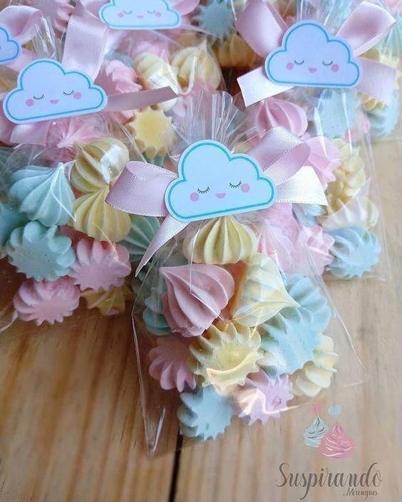 some cupcakes are wrapped in clear cellophane and have clouds on them