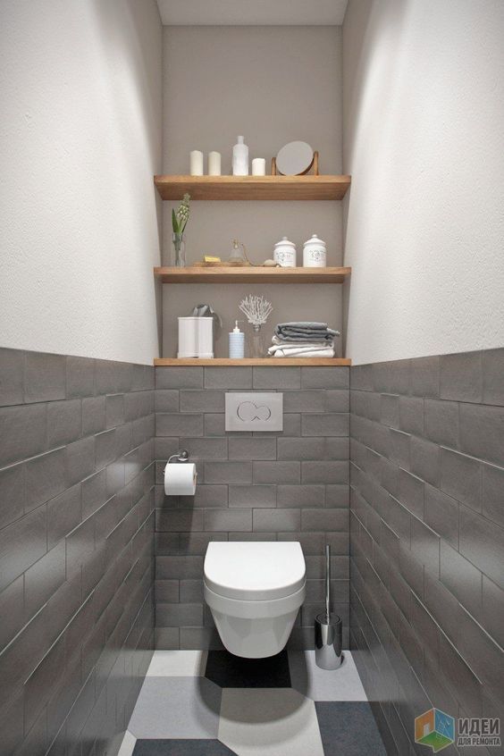 a white toilet sitting inside of a bathroom next to a black and white checkered floor