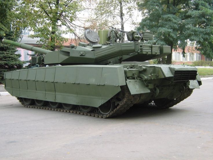 an army tank is parked on the street