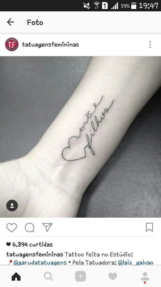 a small wrist tattoo with the word love written in cursive writing on it