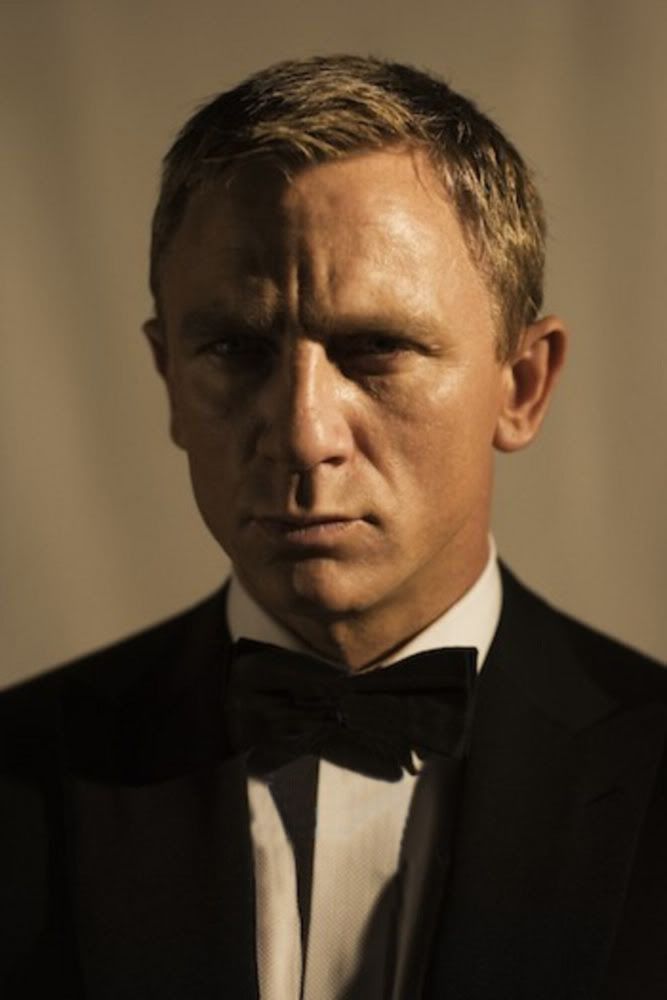 a man in a tuxedo is looking at the camera with an intense look on his face