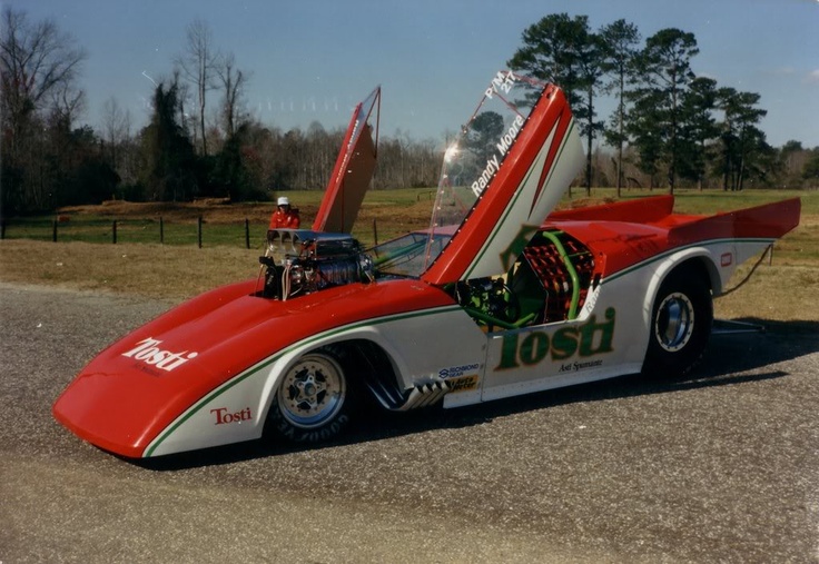 a red and white car with the hood open