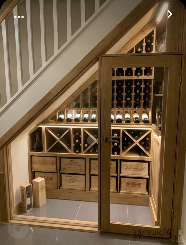 an open wine cellar under the stairs