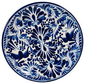 a blue and white plate with floral designs