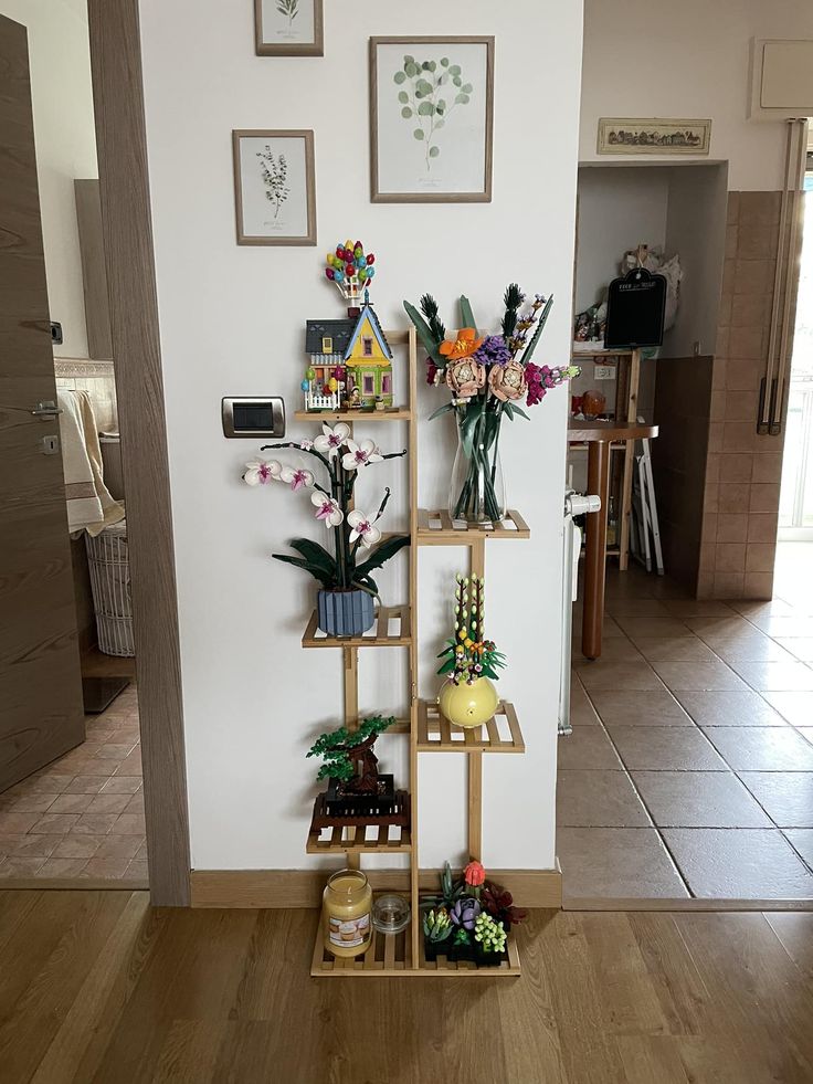 there is a shelf with flowers on it in the living room or dining room area