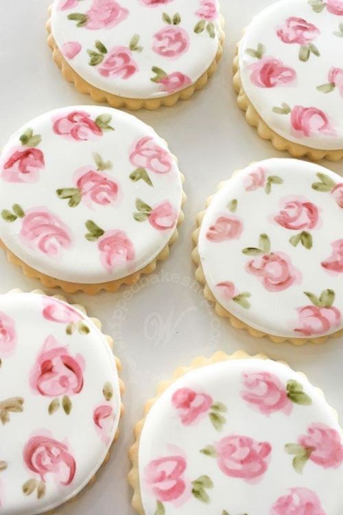 six decorated cookies with pink flowers on them