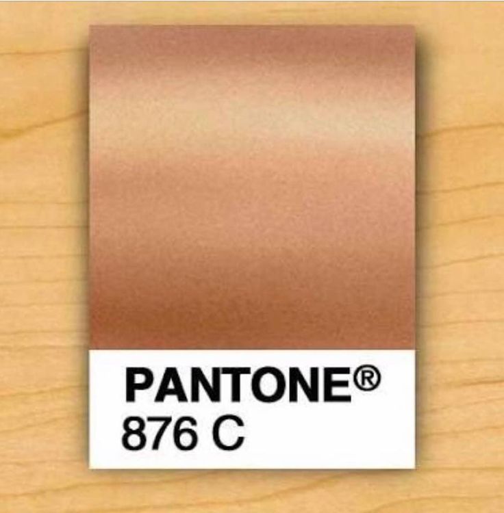 the pantone logo is shown on top of a wooden surface with a brown color