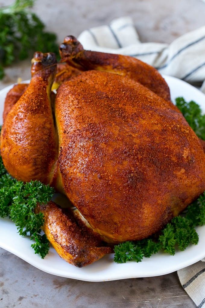 a whole chicken on a plate with parsley