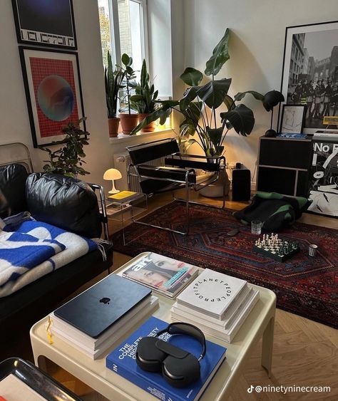 a living room filled with furniture and lots of plants