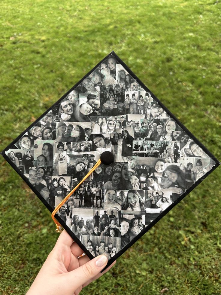 a hand holding a graduation cap with photos on it