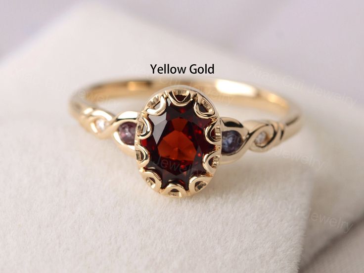 Welcome to my shop, you can find many beautiful gemstone jewelry here, and you also can ask for customized service.  Main Stone: natural garnet, oval cut, measures 6X8 mm, weight 1.74 carats. Accent Stones: Lab alexandrite and cz Metal: 14k solid yellow gold/white/rose gold/sterling silver Setting: half bezel setting  more rings: https://www.etsy.com/shop/XCjewelryStudio?ref=hdr_shop_menu It's quite comfortable for wearing and suitable for all occasions (wedding, anniversary, Christmas) styles a White Stone Finger Ring Gold, Silver Garnet Engagement Ring, Unique Dainty Rings, Vintage Garnet Rings, Garnet Ring Engagement, Garnet Ring Gold, Christmas Styles, Meaningful Rings, Garnet Wedding Rings