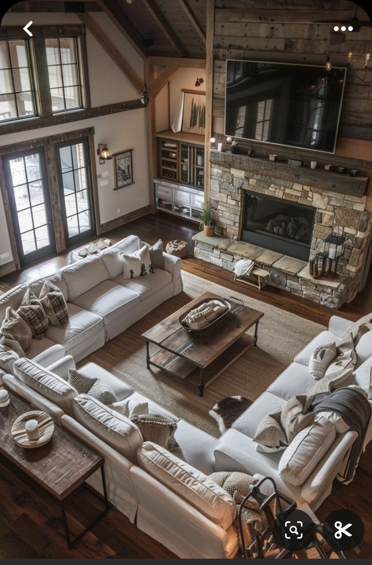 an aerial view of a living room with white couches