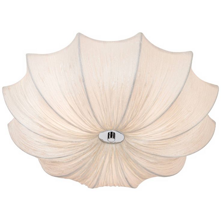 a large white flower shaped light fixture on a wall mounted ceiling fixture with a metal button in the center