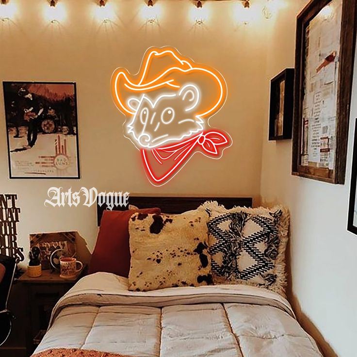 a bed room with a neatly made bed and a neon sign on the wall above it