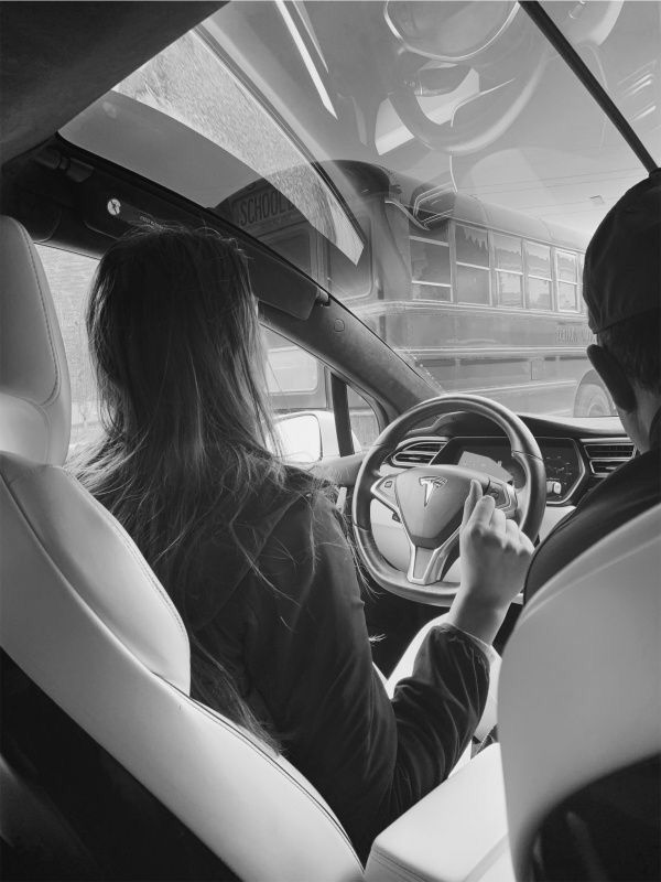 two people sitting in the driver's seat of a car