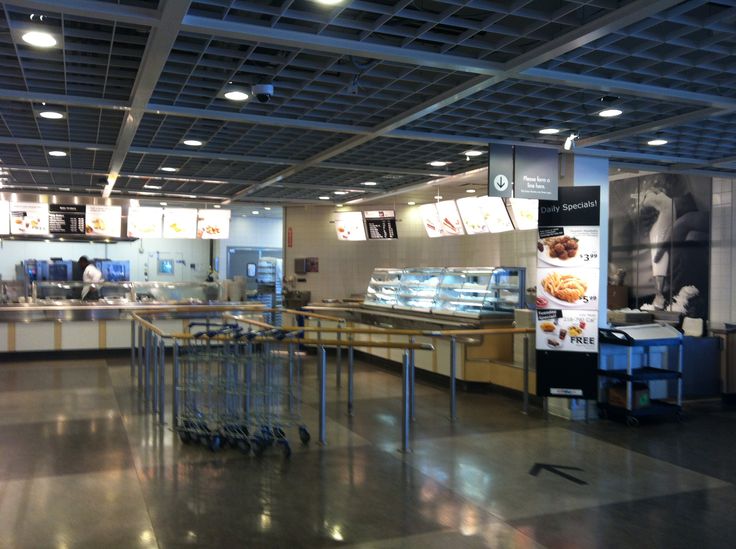 the inside of a restaurant with tables and carts in front of it's counters