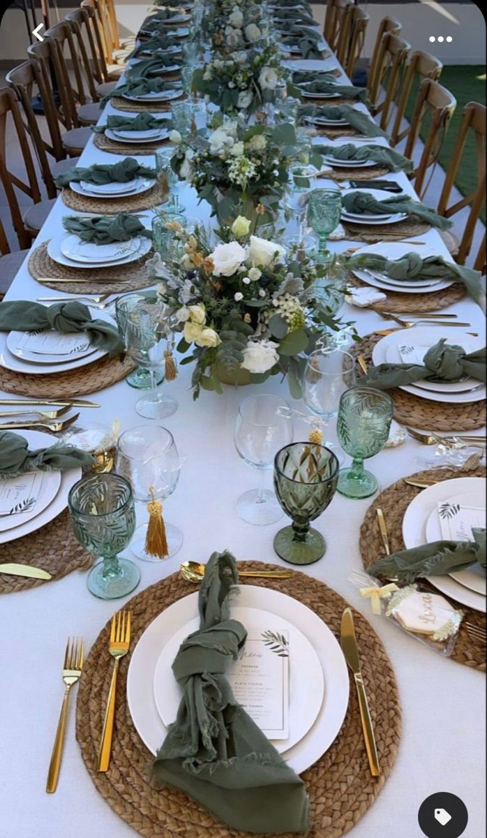 the table is set with plates and place settings