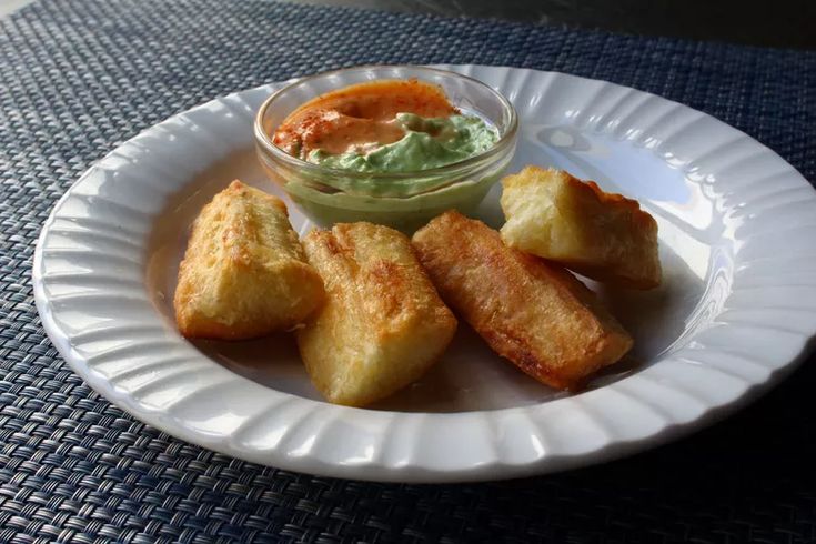 a white plate topped with tater tots and dip