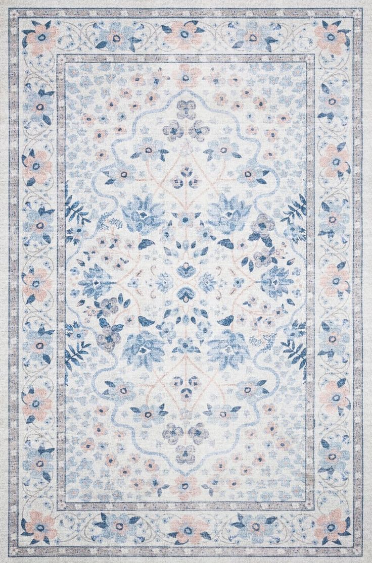 a blue and white rug with an ornate design on the bottom, surrounded by flowers