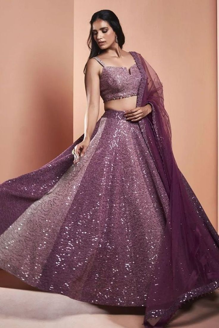 a woman in a purple and silver lehenga with sequins on it