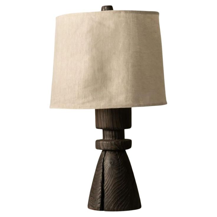 a wooden table lamp with a white shade