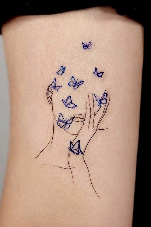 a woman's stomach with blue butterflies flying around her