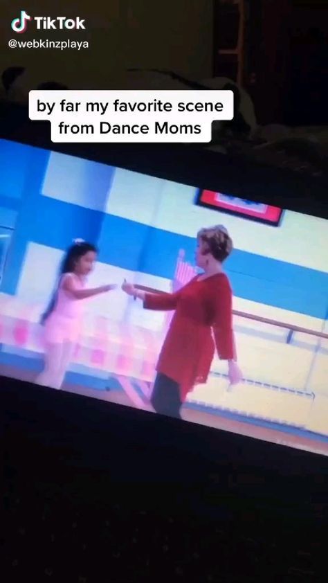 two women are dancing on the television screen