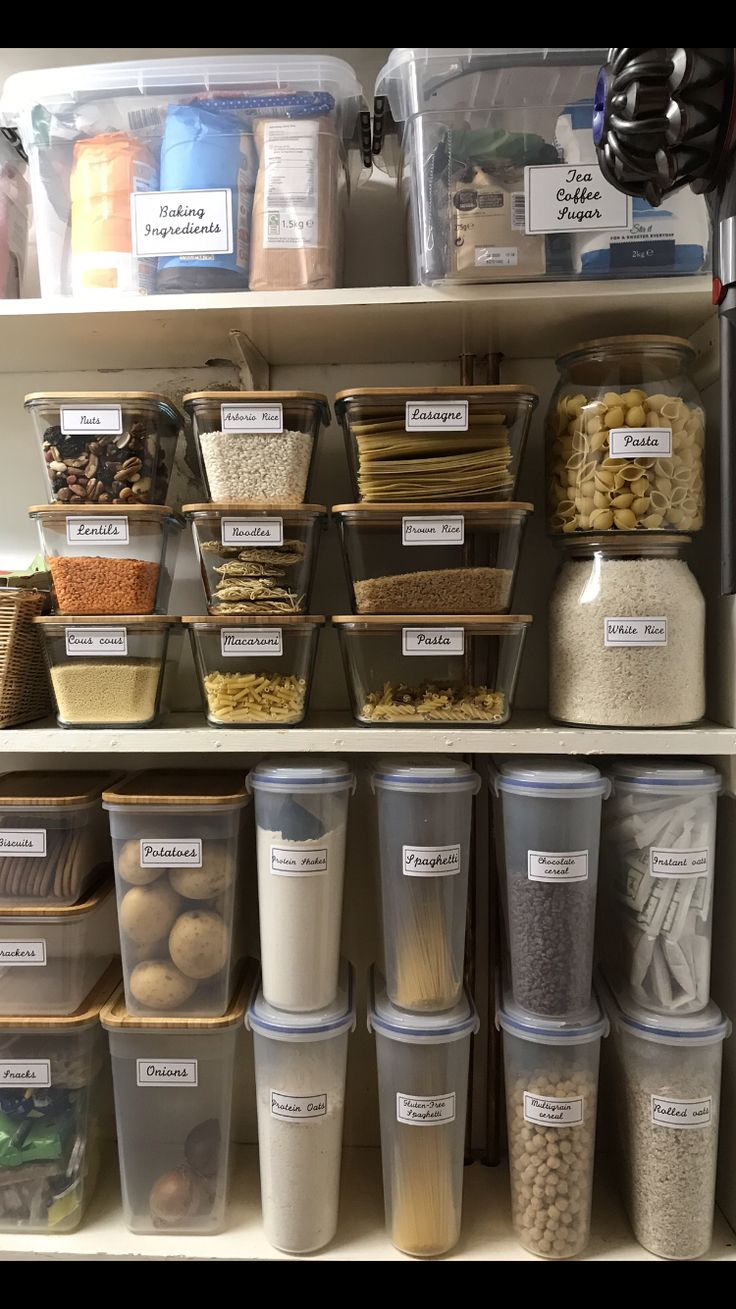 the shelves are filled with different types of food and storage containers, labeled with labels on them