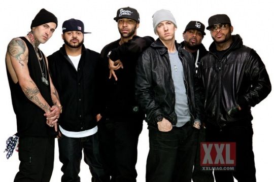 a group of young men standing next to each other in front of a white background