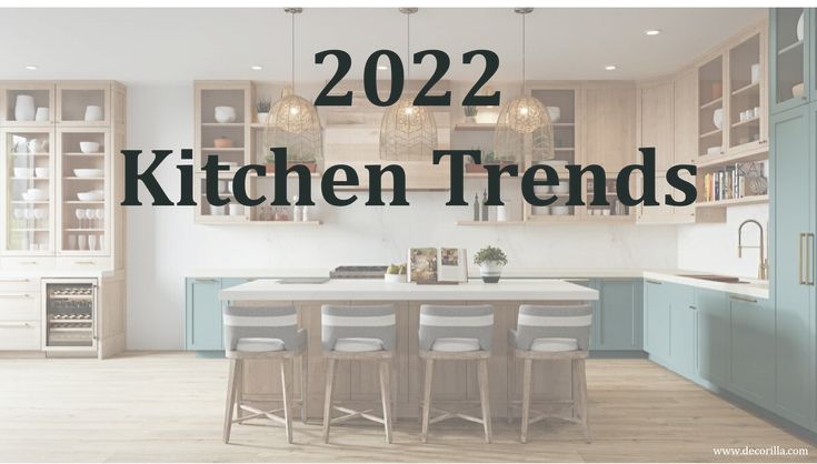 a kitchen with blue cabinets and white counter tops next to a large dining room table