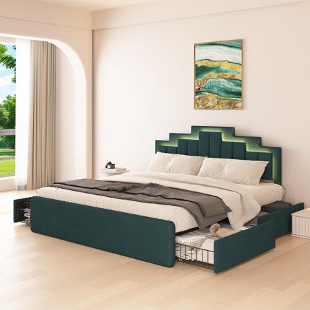 a bedroom with a large bed and green headboard on top of wooden flooring