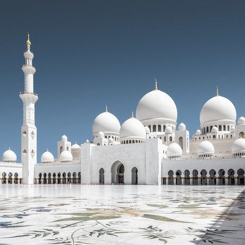 a large white building with many domes on it's sides and pillars in the middle